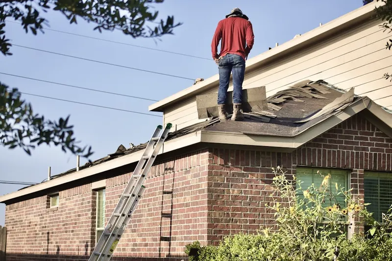 Professional roofer working on a residential roof in Morse